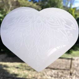 This beautiful  selenite heart has the lotus etched on it.